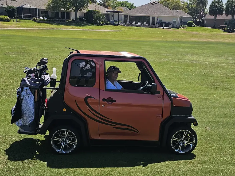 A Cool Carts golf cart on a golf course