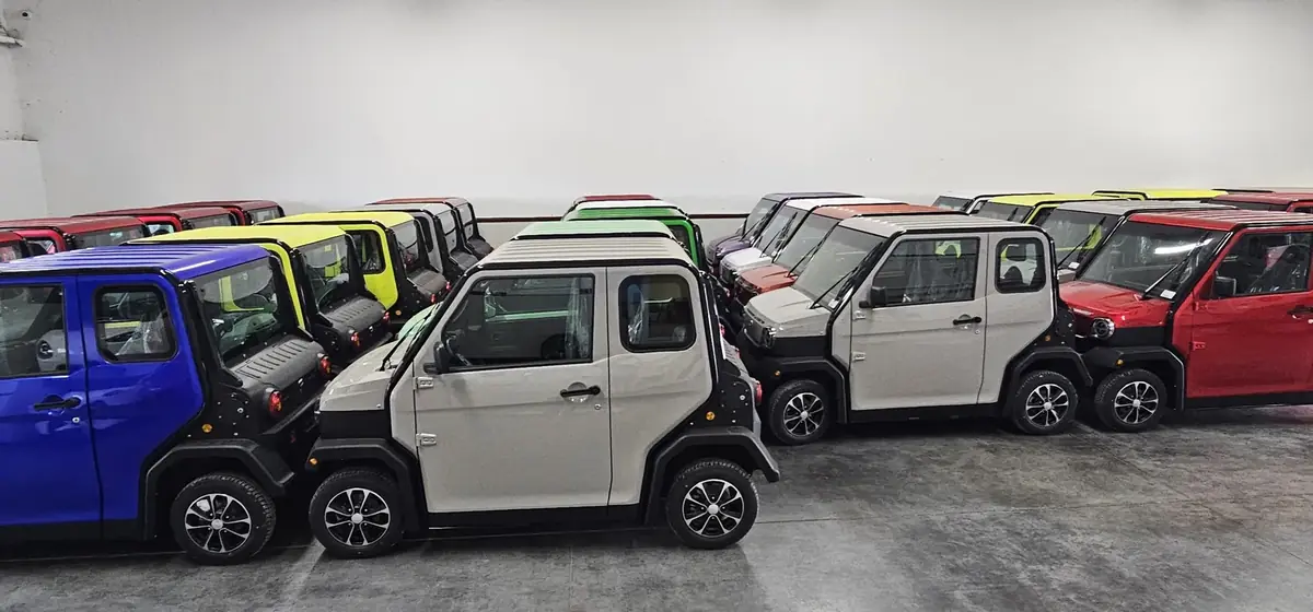 A row of Cool Carts golf carts in different colors